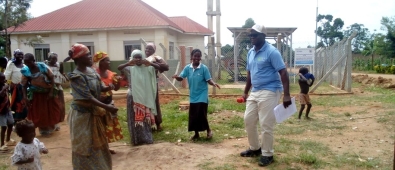 Country Director of Life Water International, Mr. Curuma Emmanuel dancing with community members 