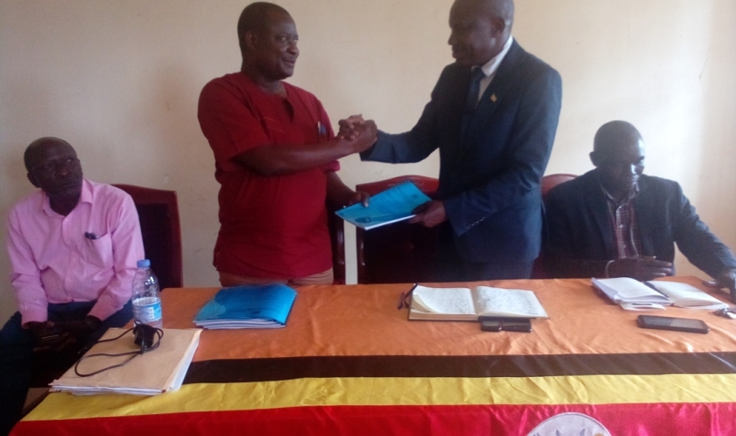 Mayuge District outgoing CAO, Mr. Magumba Eria (standing left) handed over office to new CAO, Mr. Eswilu Donath on Friday 12th Jan 2024